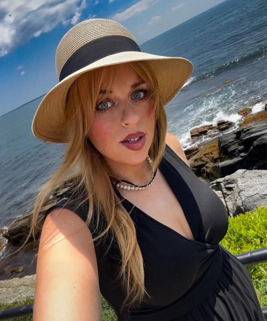 Emma Shorebreak, Northeast US travel and lifestyle content creator, at the Cliff Walk in Newport, Rhode Island