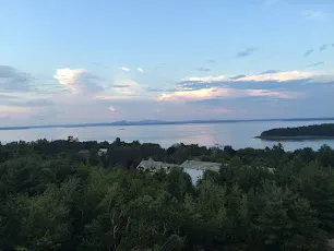 Frenchman Bay and its islands seen from above the treetops at dusk near Bar Harbor