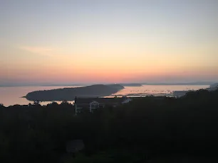 The sun setting over Frenchman Bay and its islands seen from above Bar Harbor