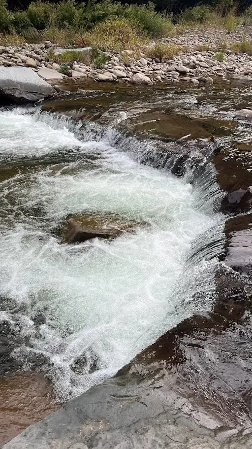 A wide cascade on a Catskill mountain stream near Claryville, water pouring over flat rock ledges