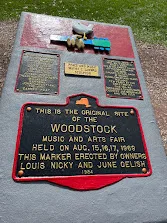 The bronze marker at Bethel reading This is the original site of the Woodstock Music and Arts Fair