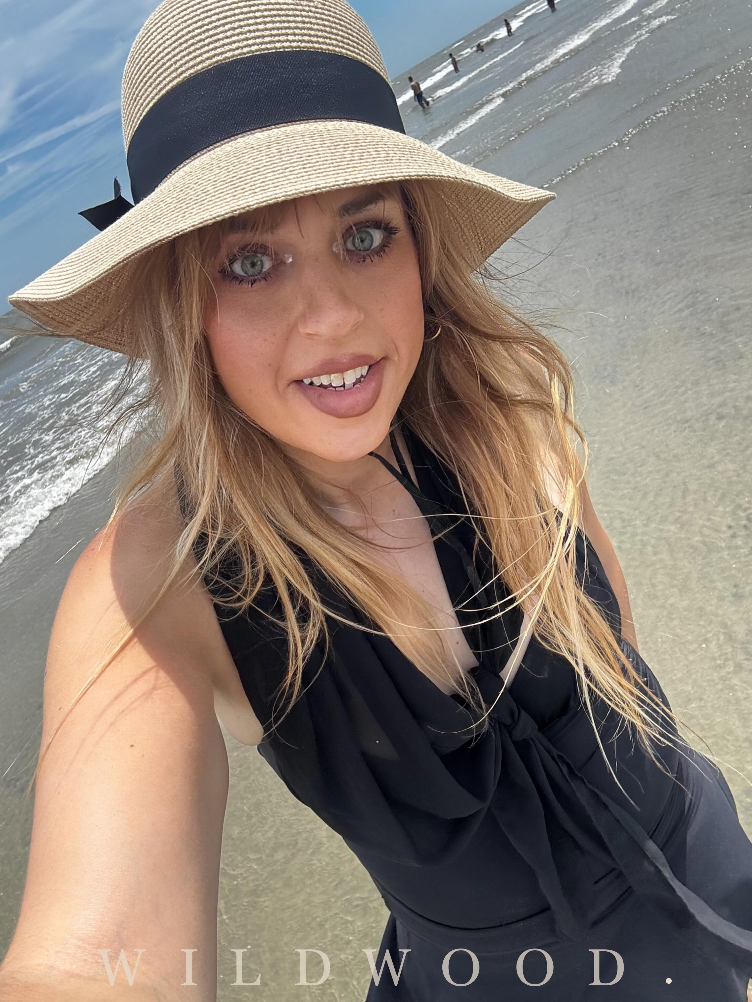 Emma Shorebreak in a Regency-style dress walking the Wildwood New Jersey boardwalk and seawall
