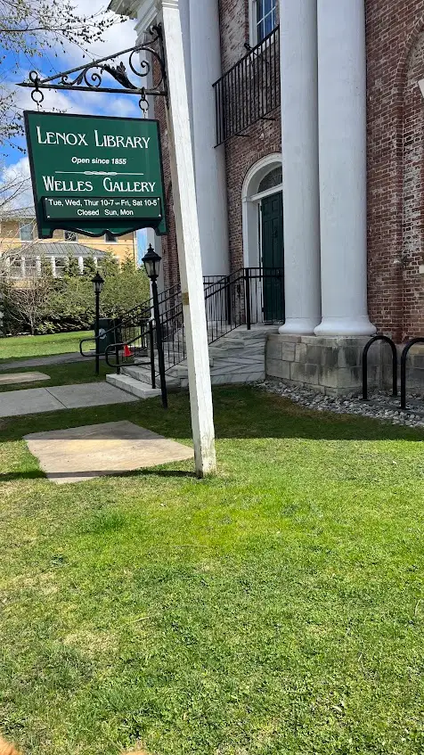The Lenox Library sign in front of the brick, white-columned building that once served as the Berkshire County courthouse