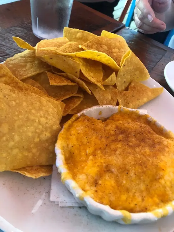 A dish of warm crab dip with grilled flatbread on a picnic table at Crooked Hammock Brewery in Lewes