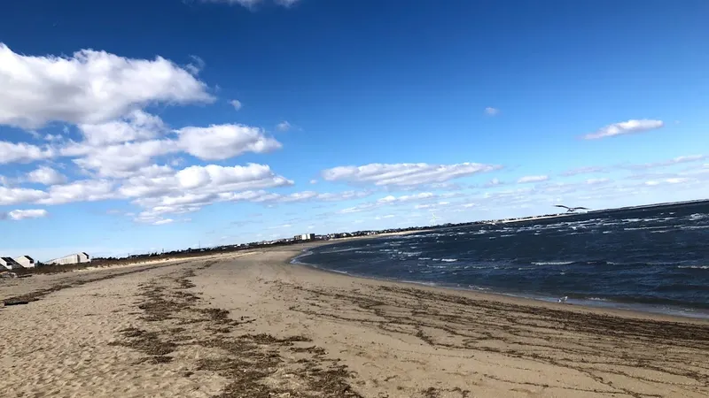 The wide winter beach at Cape Henlopen near Lewes, Delaware, looking toward the breakwater
